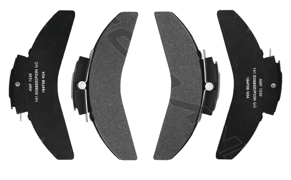 Automann severe duty air disc brake pads with metal backing and friction material for heavy-duty brake applications.