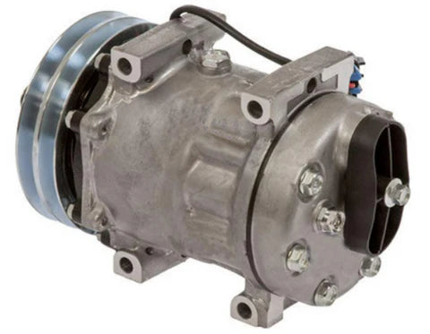 Automann 830.31023 air conditioning compressor 7H15 type with visible metal components and electrical connections.