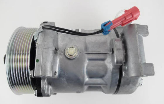 Automann 830.31069 air conditioning compressor 7H15 type, showing metallic compressor unit with hoses and fittings.